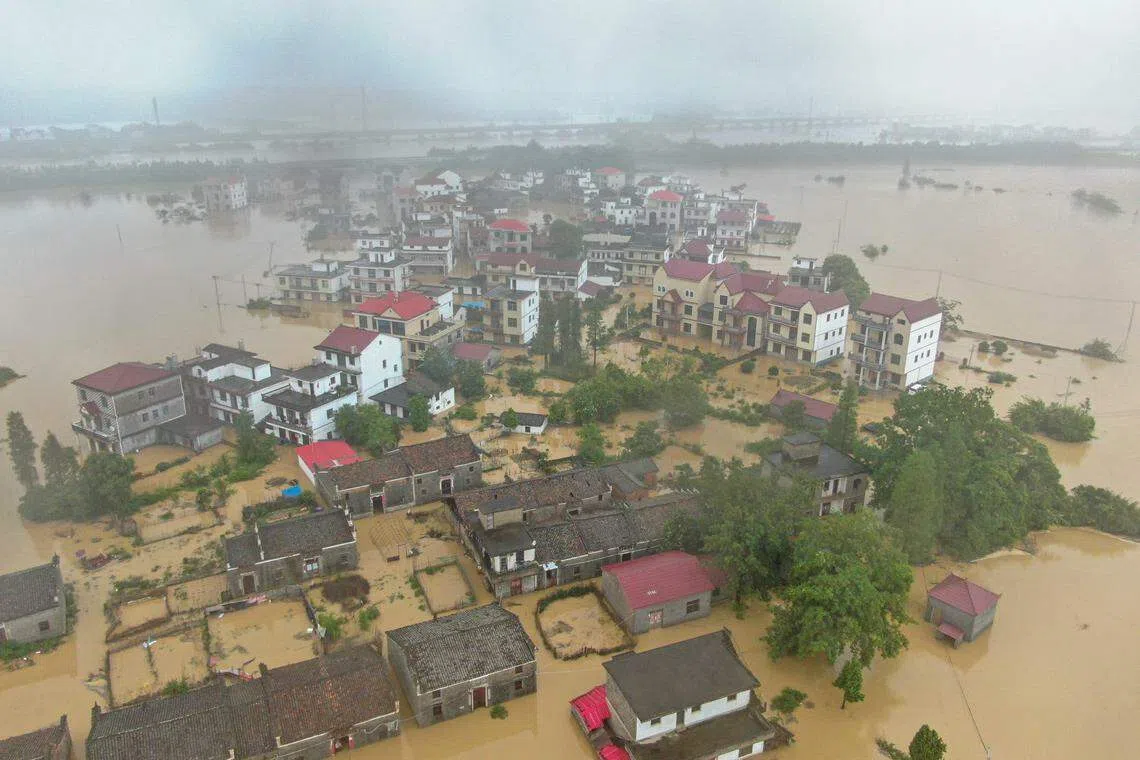 江西宜春丰城市丽村镇清丰河堤下江段河堤上星期六（5月6日）上午出现约30米溃口，导致下游四个村庄被淹，约220名民众被困。图为航拍清丰堤河堤溃口现场附近被淹的村庄和农田。（中新社）