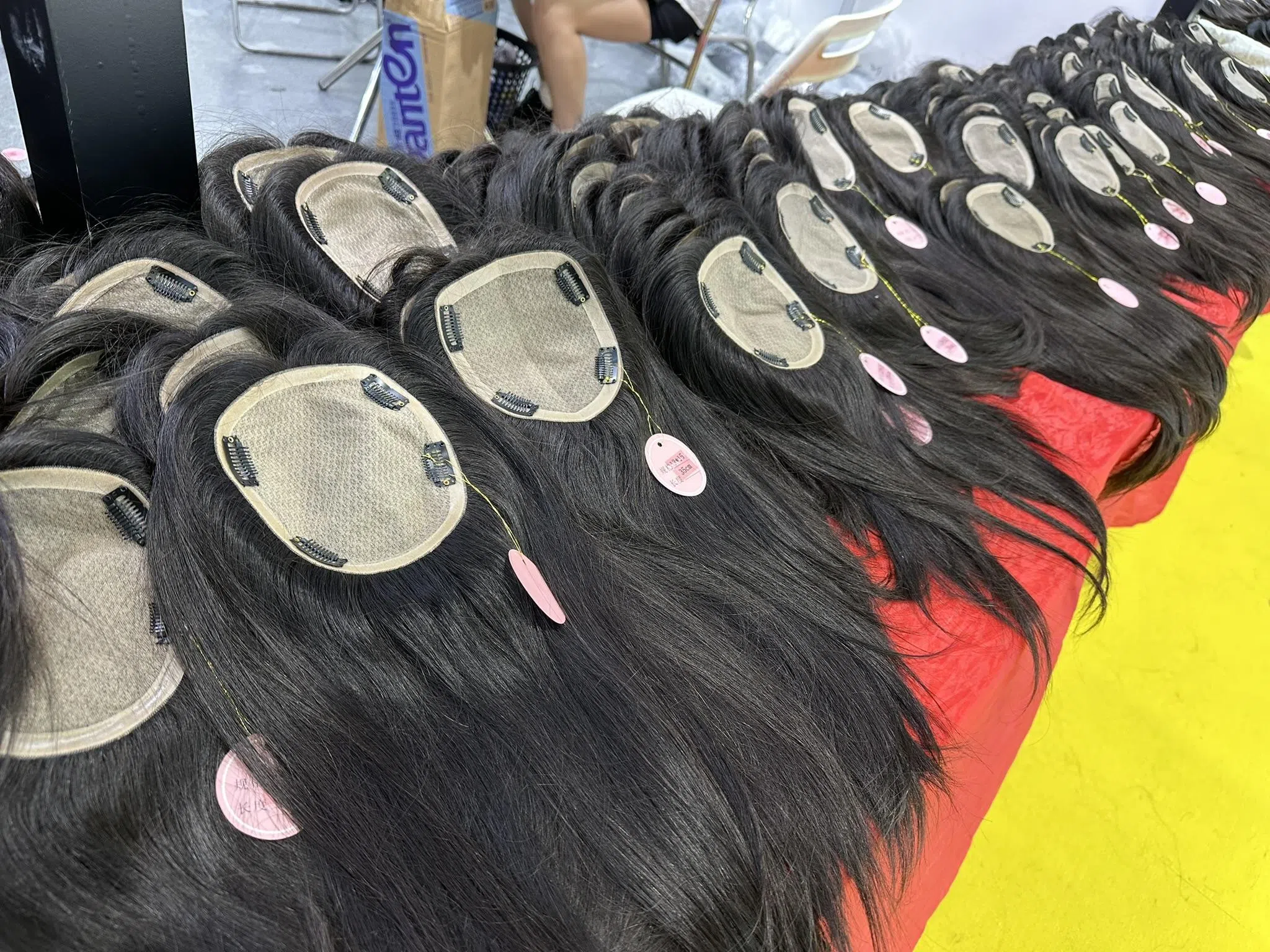 随着中国人工成本攀升，许多较低端的假发编织工作已逐渐被外包到朝鲜。图为由朝鲜织发师手工编织的真人发丝假发。（林煇智摄）