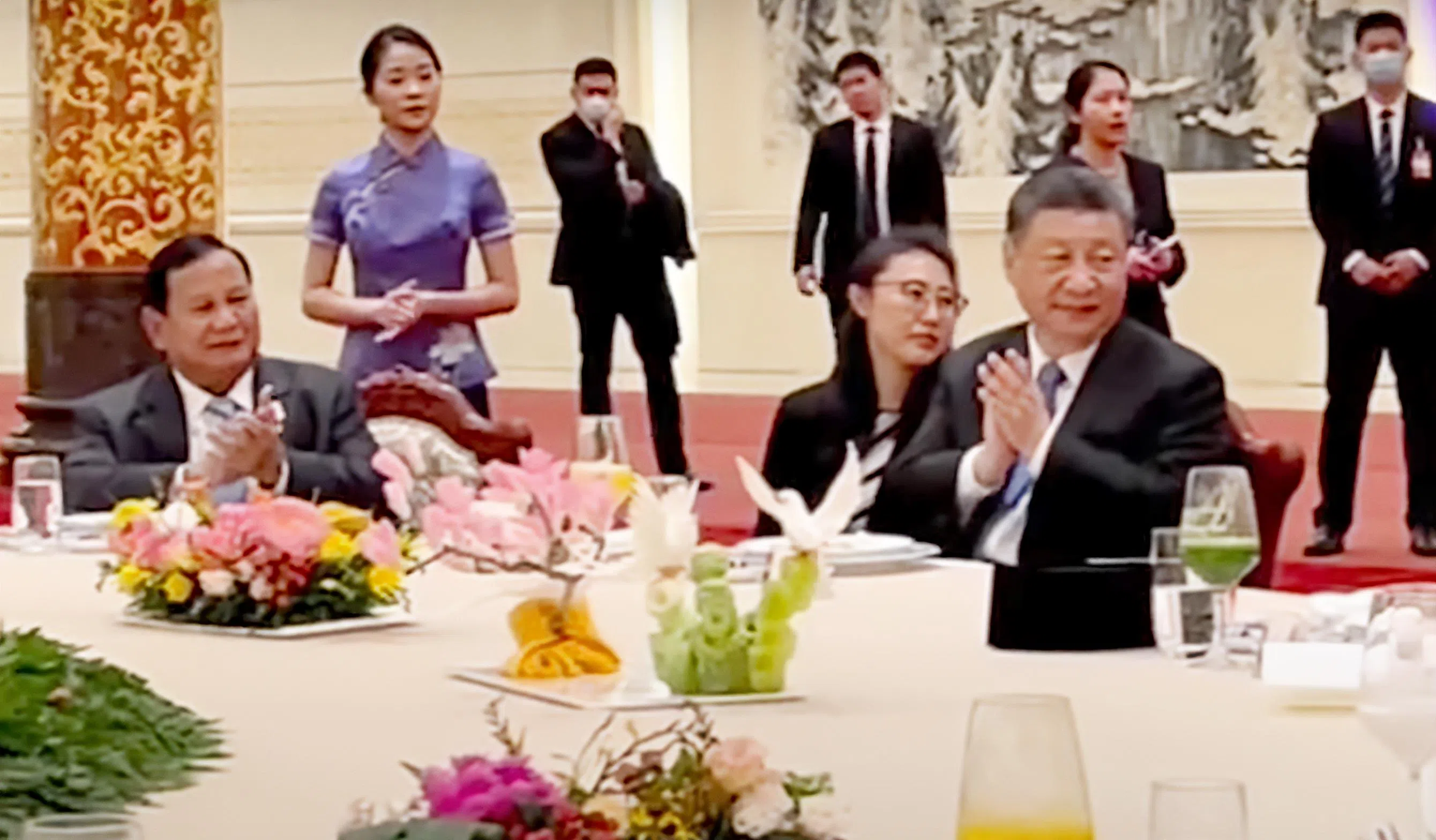中国国家主席习近平（右）、印尼当选总统普拉博沃（左）随着《歌唱祖国》的音乐拍手助兴。（视频截图）
