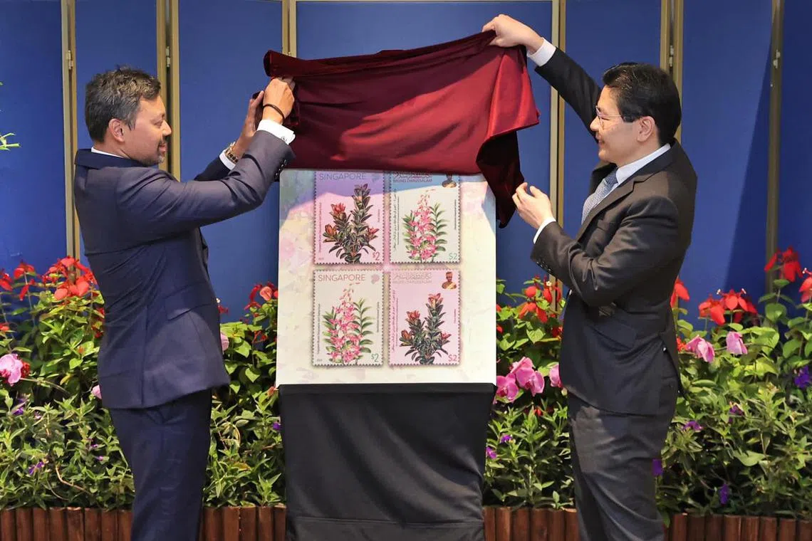 黄循财总理（右）和应他邀请到访我国的文莱王储比拉赫，共同为纪念新文建交40周年发行的邮票揭幕。（取自黄循财总理脸书）