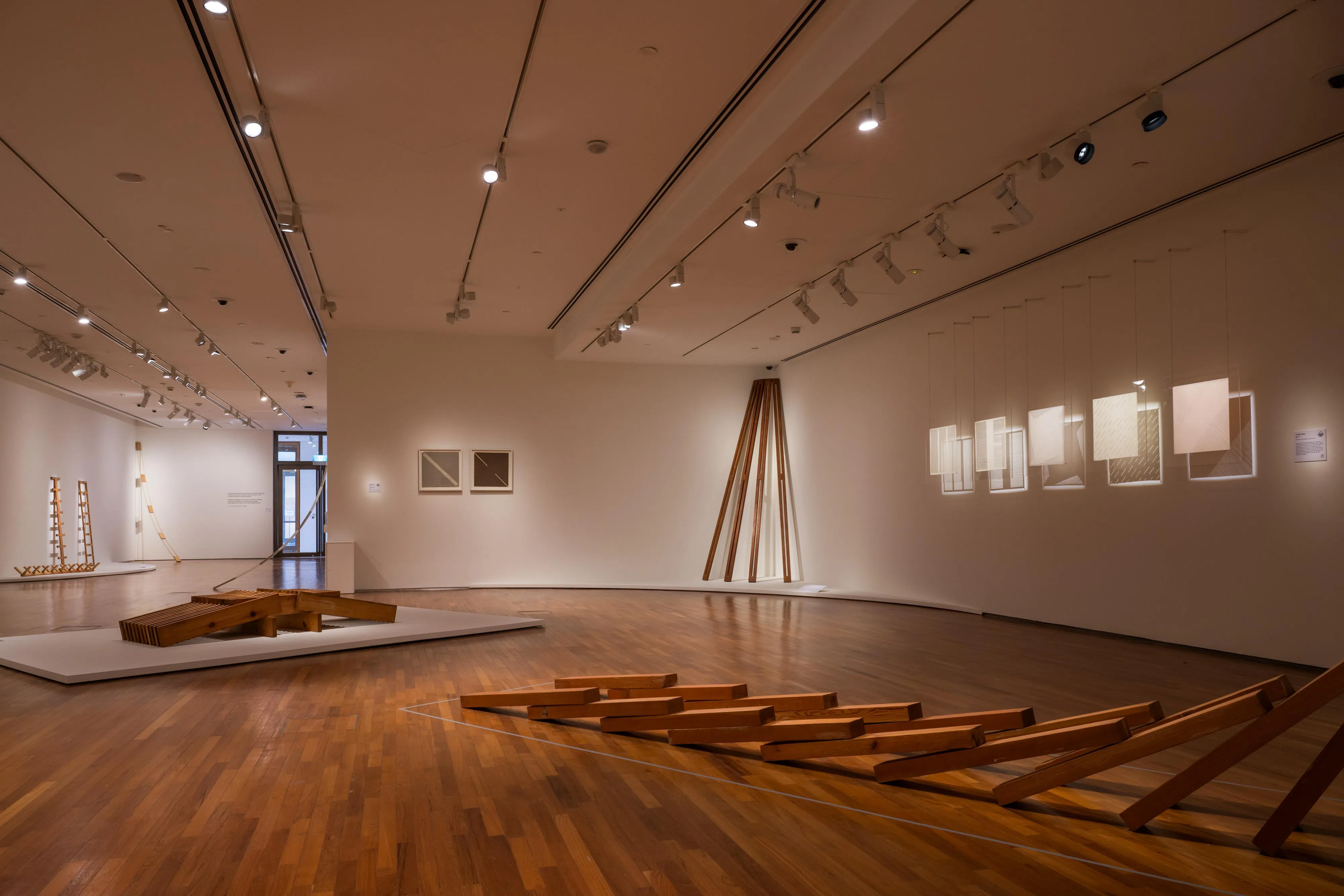 林真金以木材创作雕塑，右为松木板雕塑《伊洛瓦底》。（国家美术馆提供）