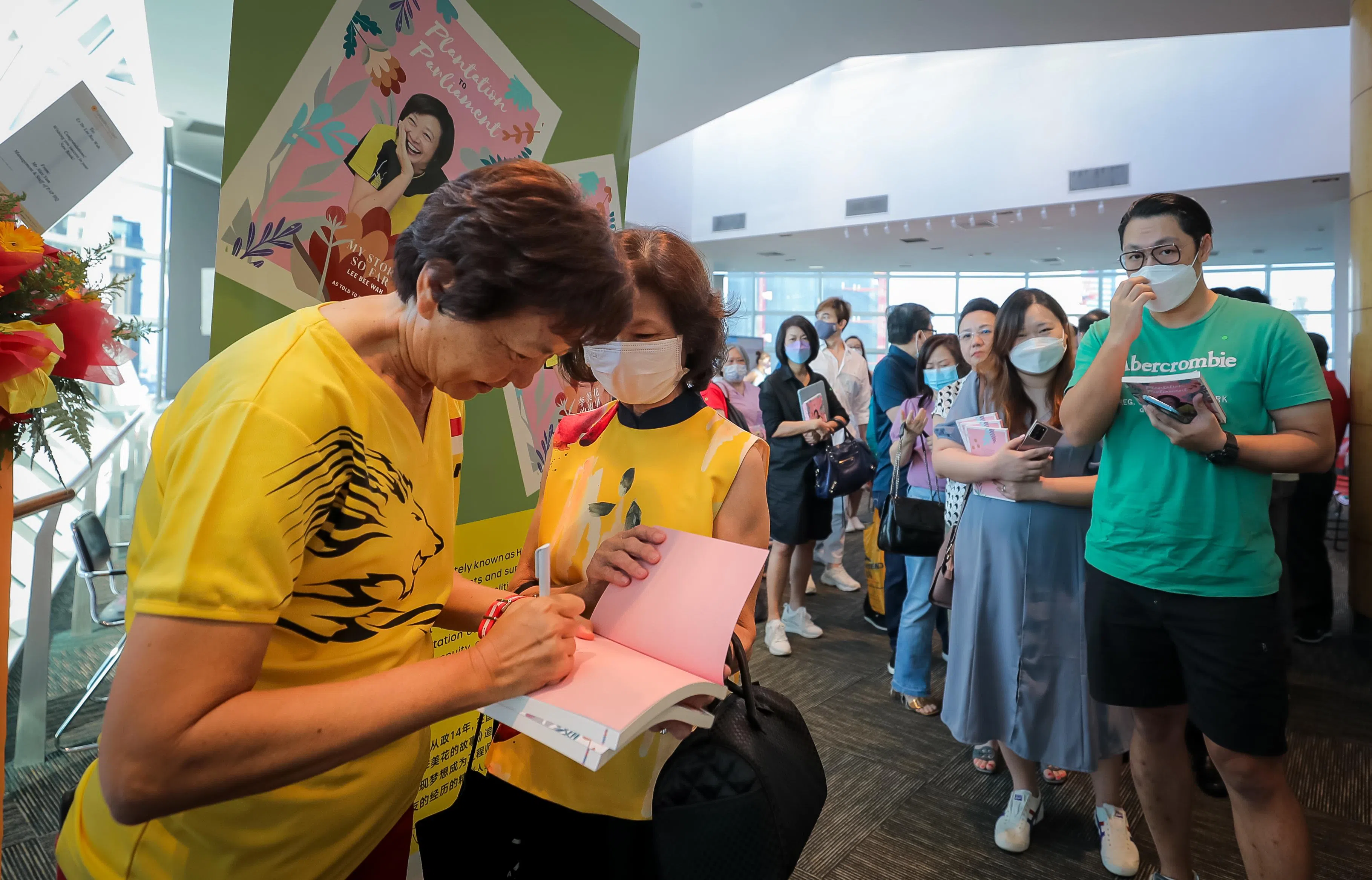 以中英文同时出版，前国会议员李美花的自传《从胶园到国会》大受欢迎，图为李美花2022年6月4日在国家图书馆发布新书时，为读者签名。（档案照片）
