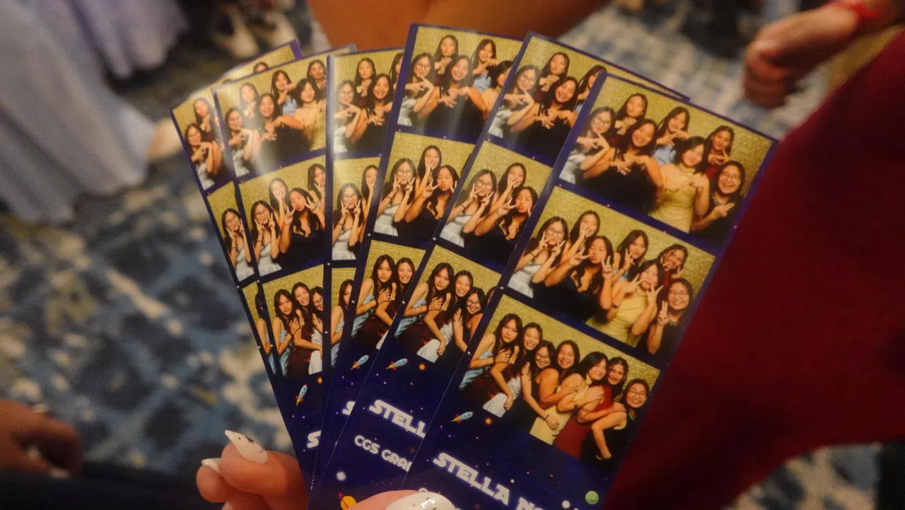 宴会厅外设有照相亭，师生可随时拍照留念。图为照相亭打印出来的照片。（黄思瑞摄）