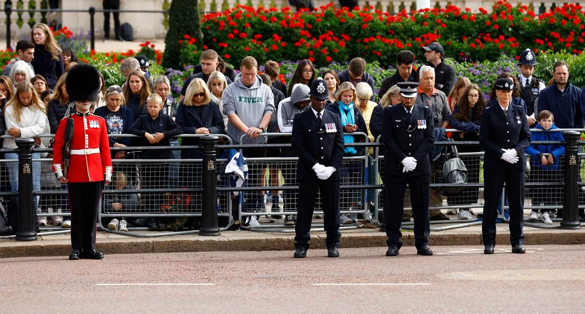 民众与军警人员低头默哀。（路透社）