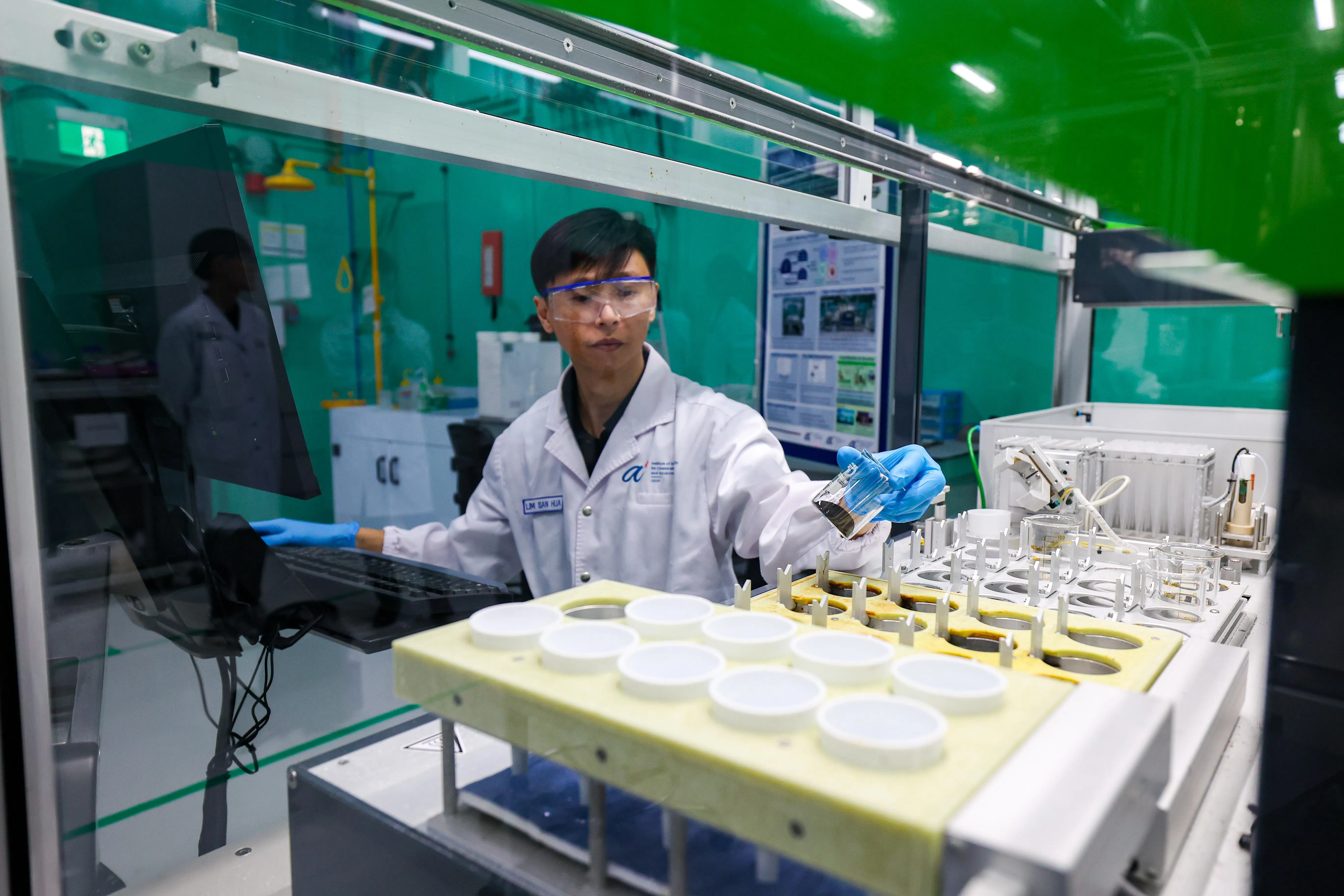 研究团可以同时测试16种催化剂，并利用机器学习技术，继续优化催化剂研发。（林明顺摄）