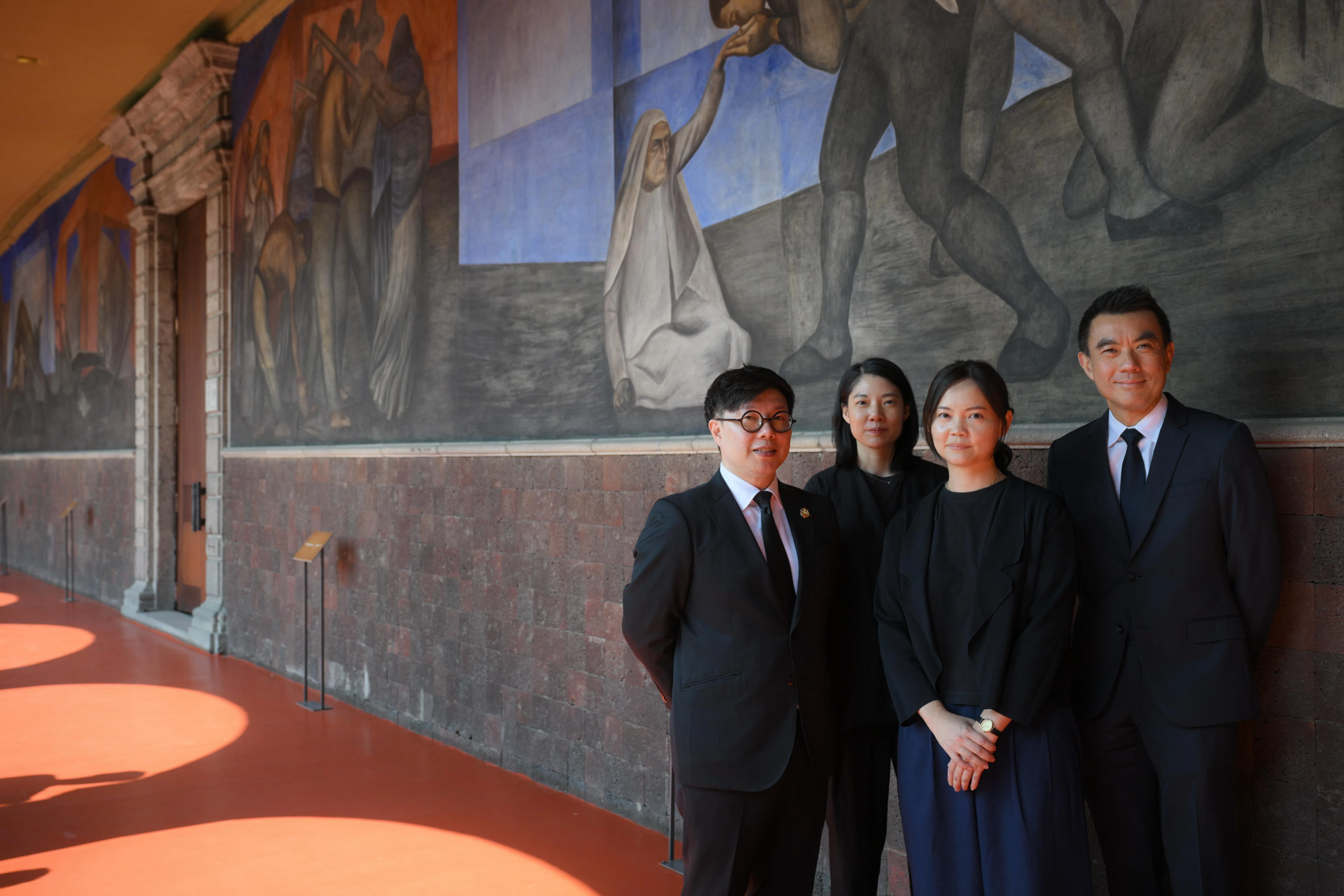 亚洲文明博物馆馆长温俊玉（左起）、新加坡国家美术馆策展人张慧敏、郑嘉韵、馆长兼总裁陈维德在墨西哥城圣伊尔德丰索学院壁画前合影。（海峡时报）