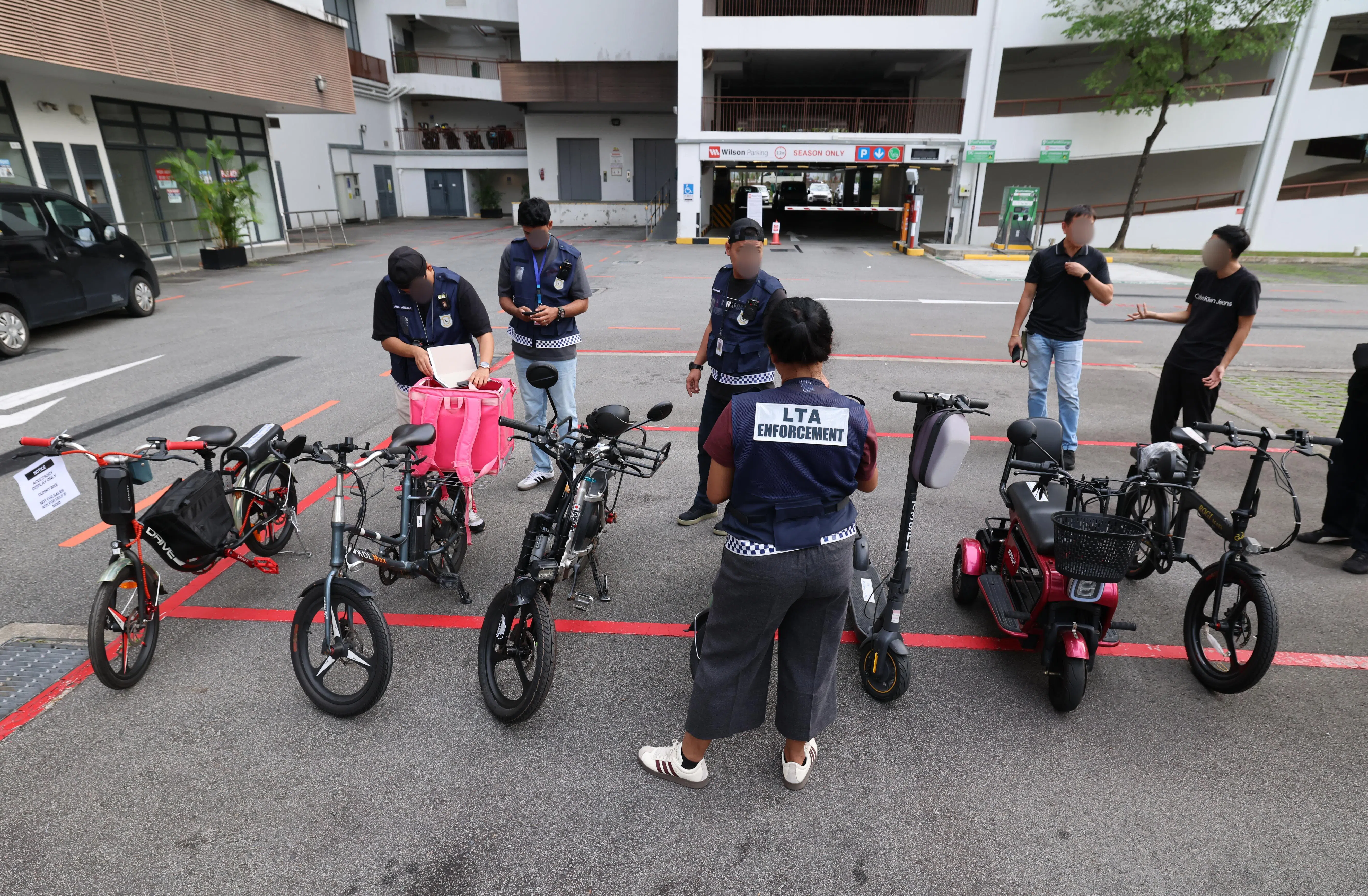 陆交局星期一突击兀兰一带工业区内的零售商，图为执法人员在检查零售商店内的不同代步工具。（梁麒麟摄）