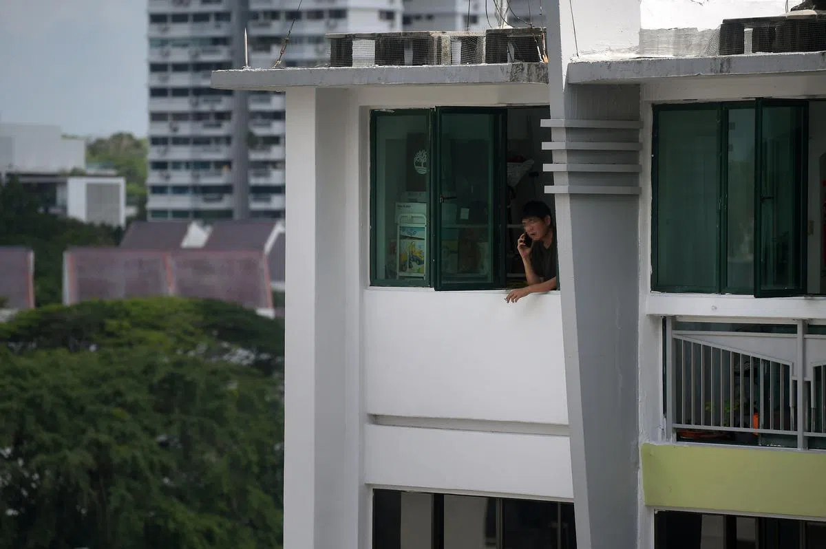 尽管政府整体控烟有成，住宅区的二手烟问题却相应缓解，政府在应对这个问题上也似乎力有未逮。图为一名男子在大巴窑住家窗边吸烟。（海峡时报）