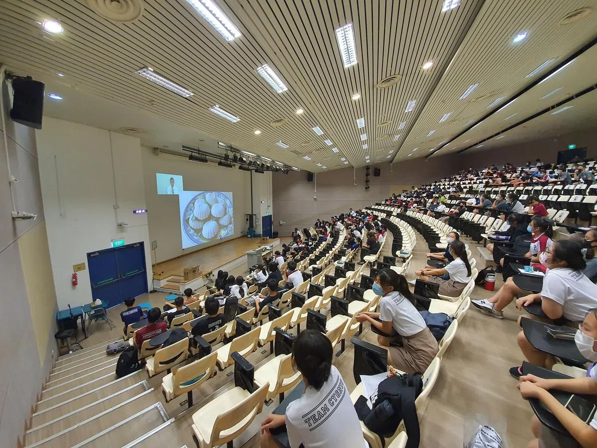 淡滨尼美廉初院高一学生分批在不同讲堂，透过线上直播，参加本地导演陈子谦以“味蕾的记忆——从电影人的视角看传统美食”为题的讲座。（淡滨尼美廉初院提供）