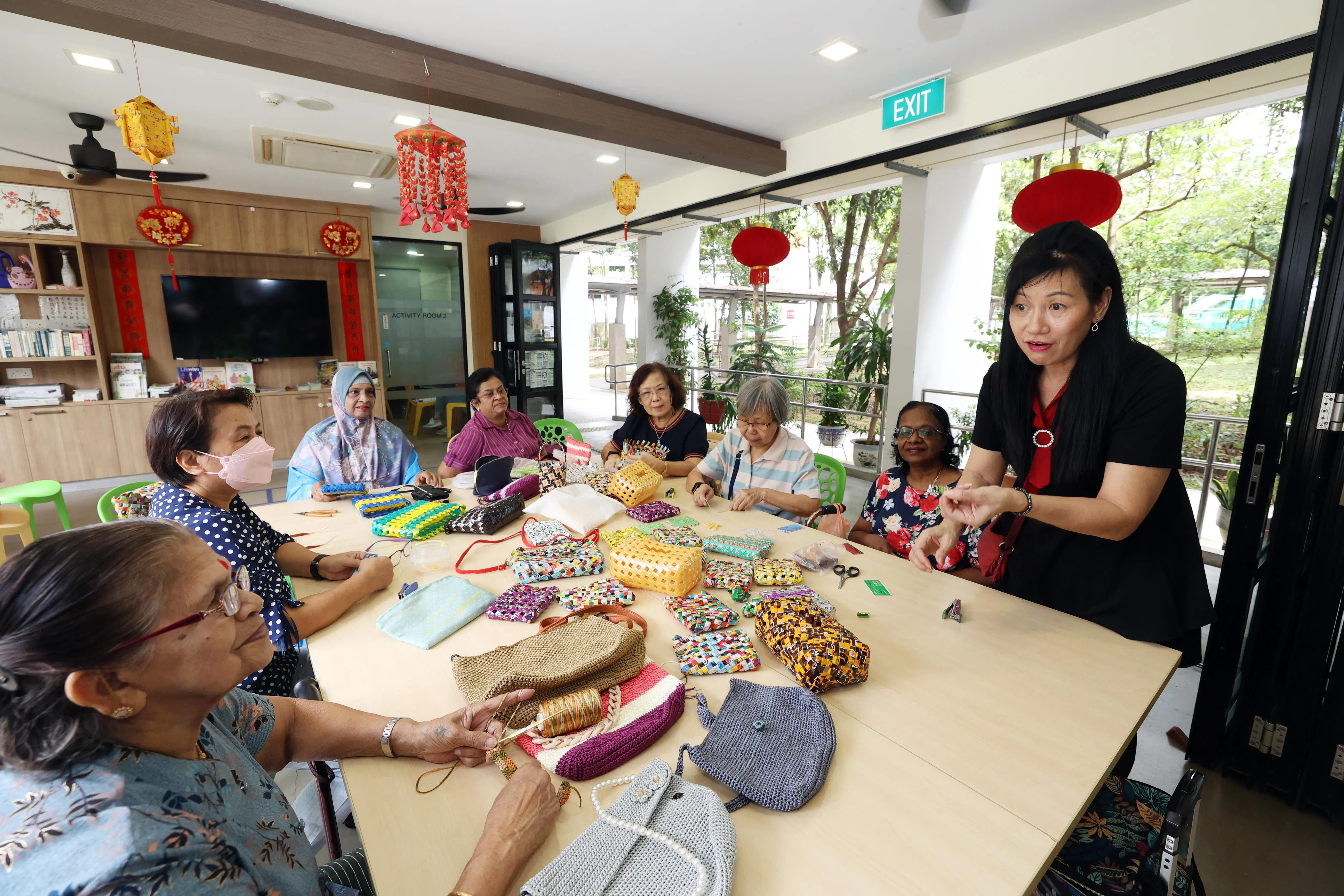 养生村里，由居民为居民设计的活动越来越普遍，像家庭主妇蔡丽金（站立者）负责的手工班，开了快四年，每班爆满。（邝启聪摄）