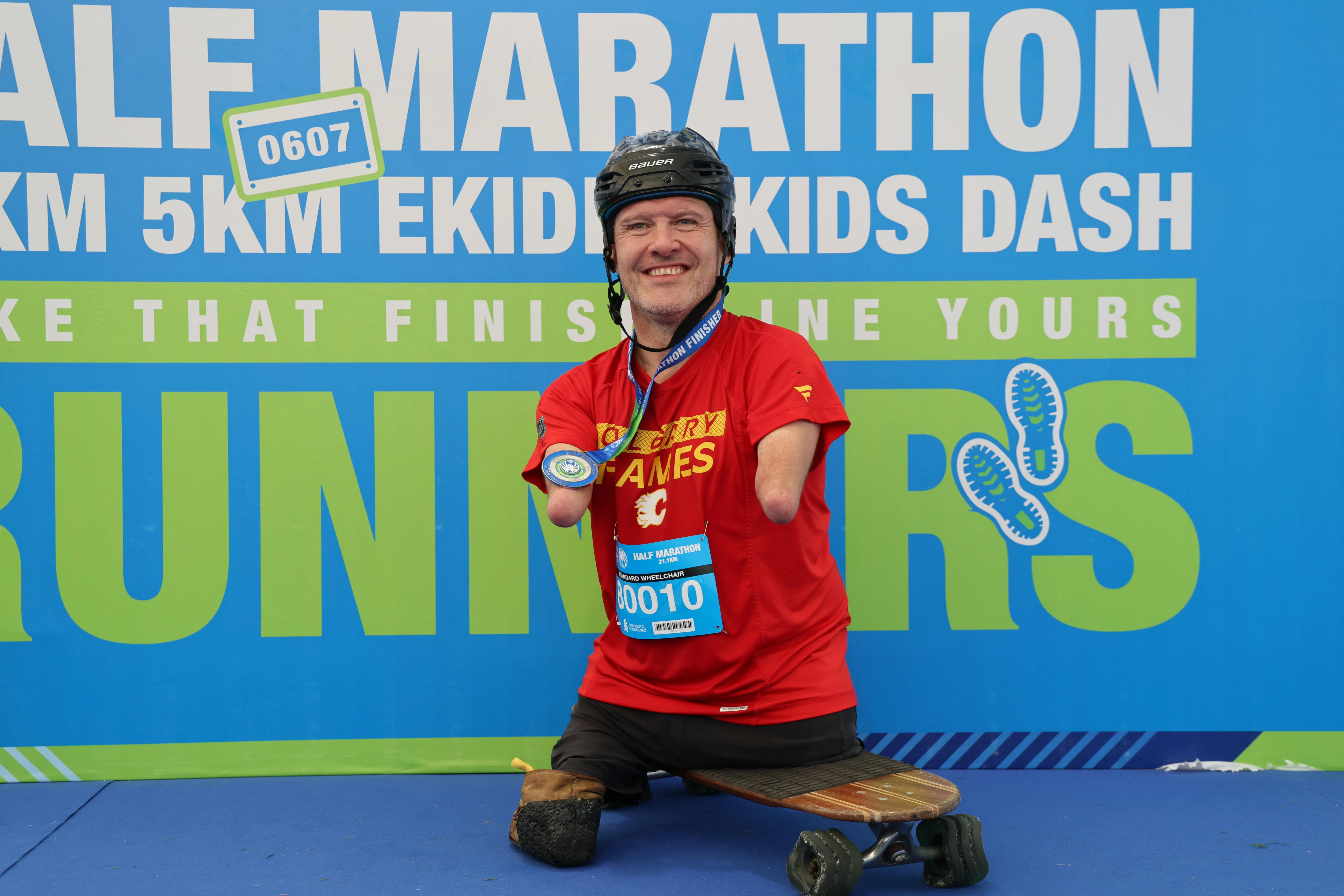 拿到完赛奖牌，科赫开心拍照。（梁麒麟摄）