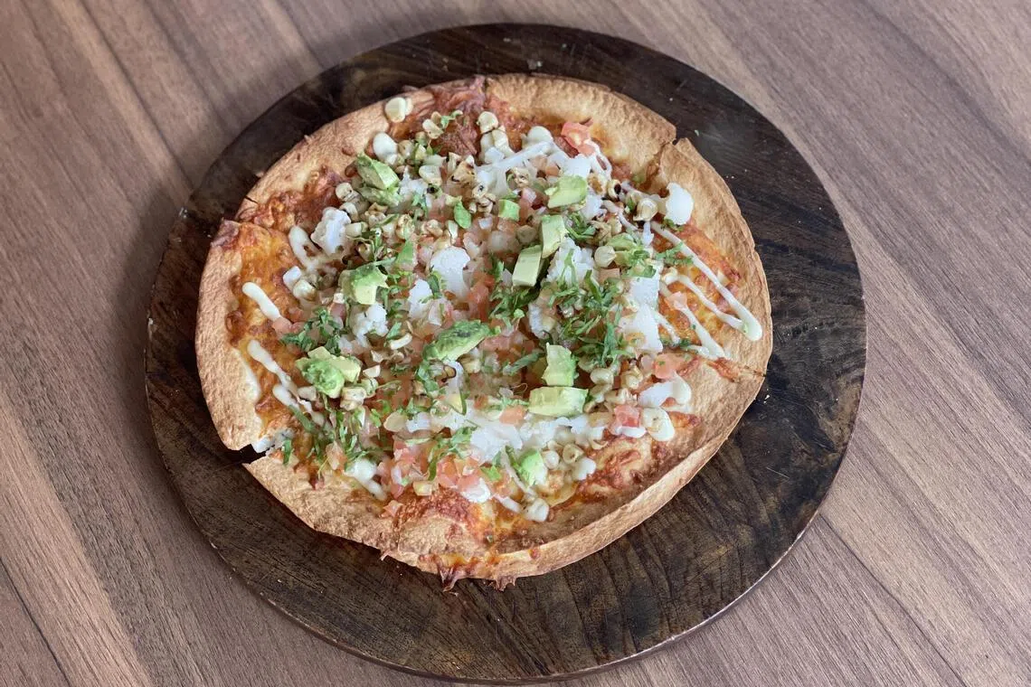 墨西哥餐馆Tomatillo的芝士披萨，具备四种芝士的醇厚奶香。（黄靖晶摄）