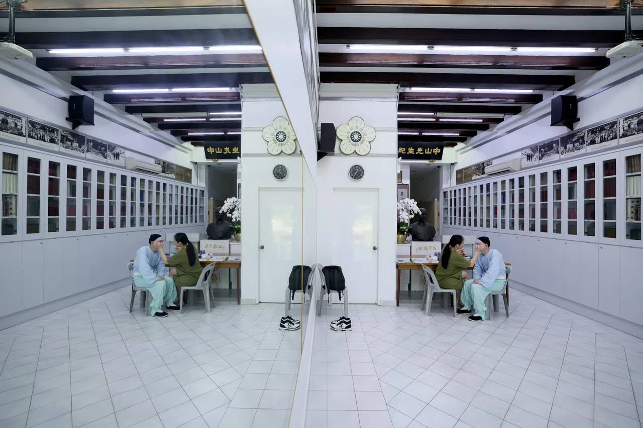 同德书报社一楼主空间内，一侧是整排书柜，另一侧则是整片落地镜。（龙国雄摄）