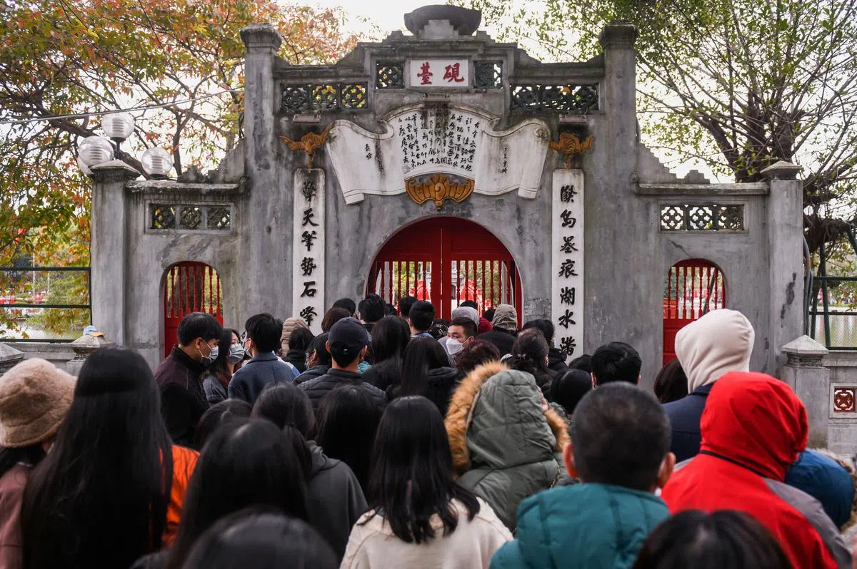 为了辞旧迎新，越南民众纷纷赶往当地著名的还剑湖，祈求新年的祝福和好运。（路透社）