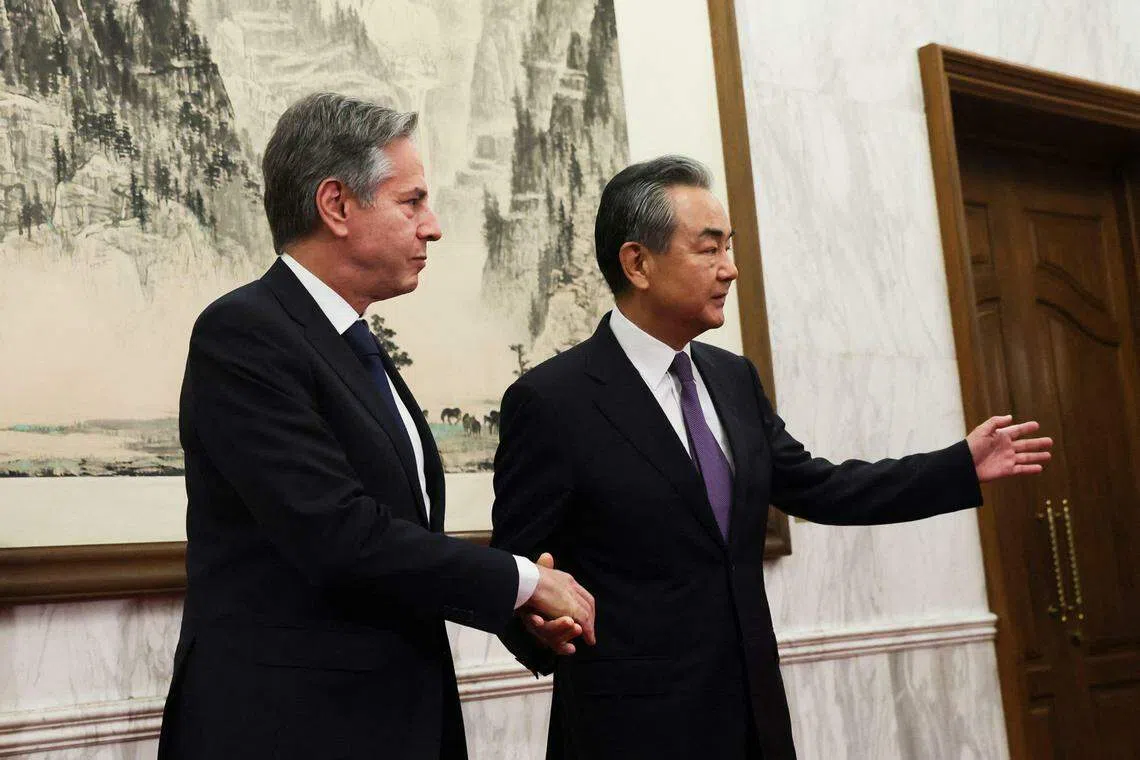 王毅与布林肯握手合照后，指引布林肯进入会议室。（法新社）