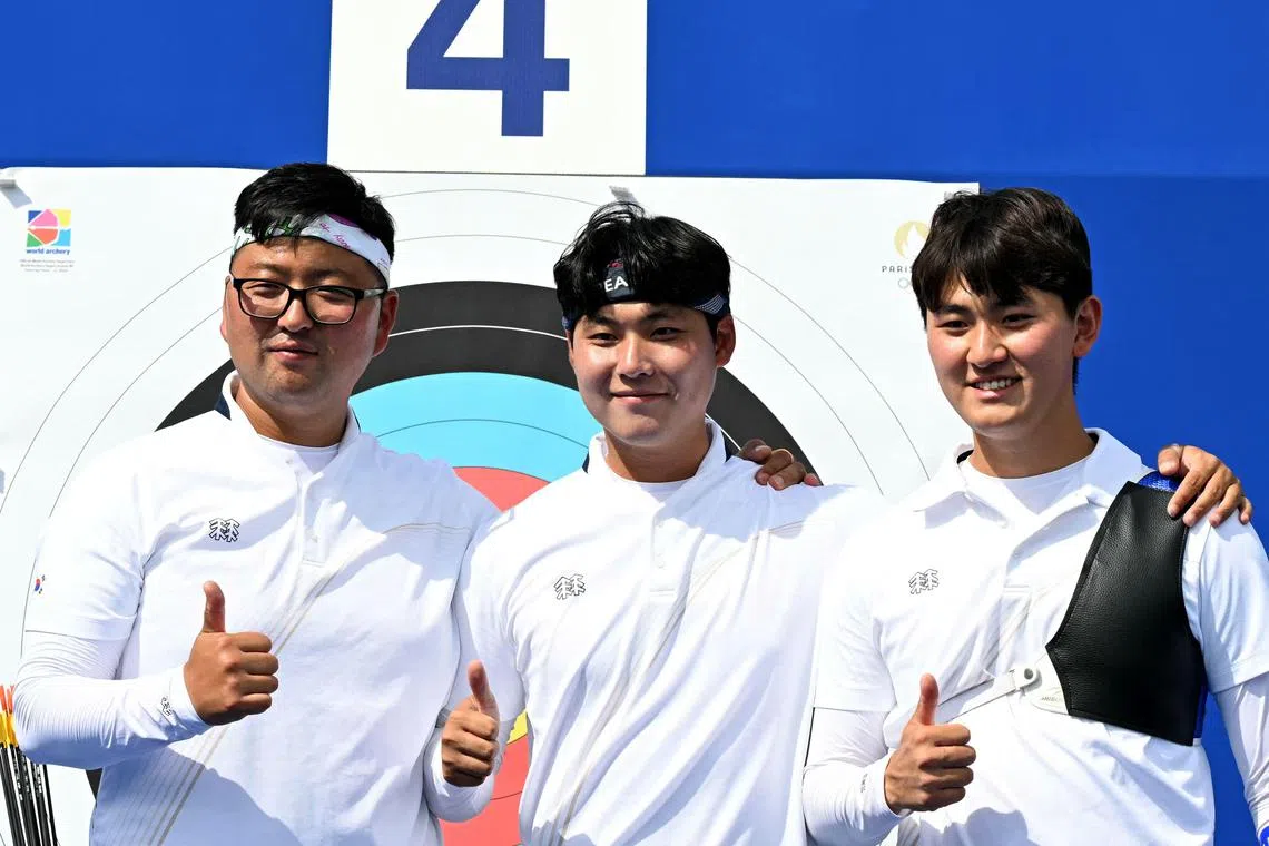 韩国男队“三箭客”金优镇、李雨锡和金济德，在结束比赛后合照。（法新社）