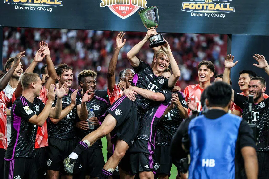 拜仁慕尼黑8月2日在新加坡国家体育场以4比3战胜利物浦，金玟哉（后排右一）随队捧杯庆祝。（关俊威摄）