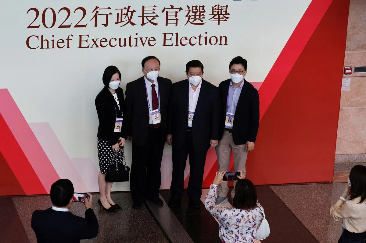 香港选委今早在投票站外合照留念。（路透社）
