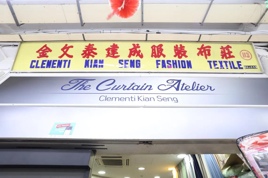 虽然添了一个洋气的店名，金文泰建成服饰布庄仍保留原来的招牌，作为对创办人黄温殿和刘玲的尊重。（郑一鸣摄）