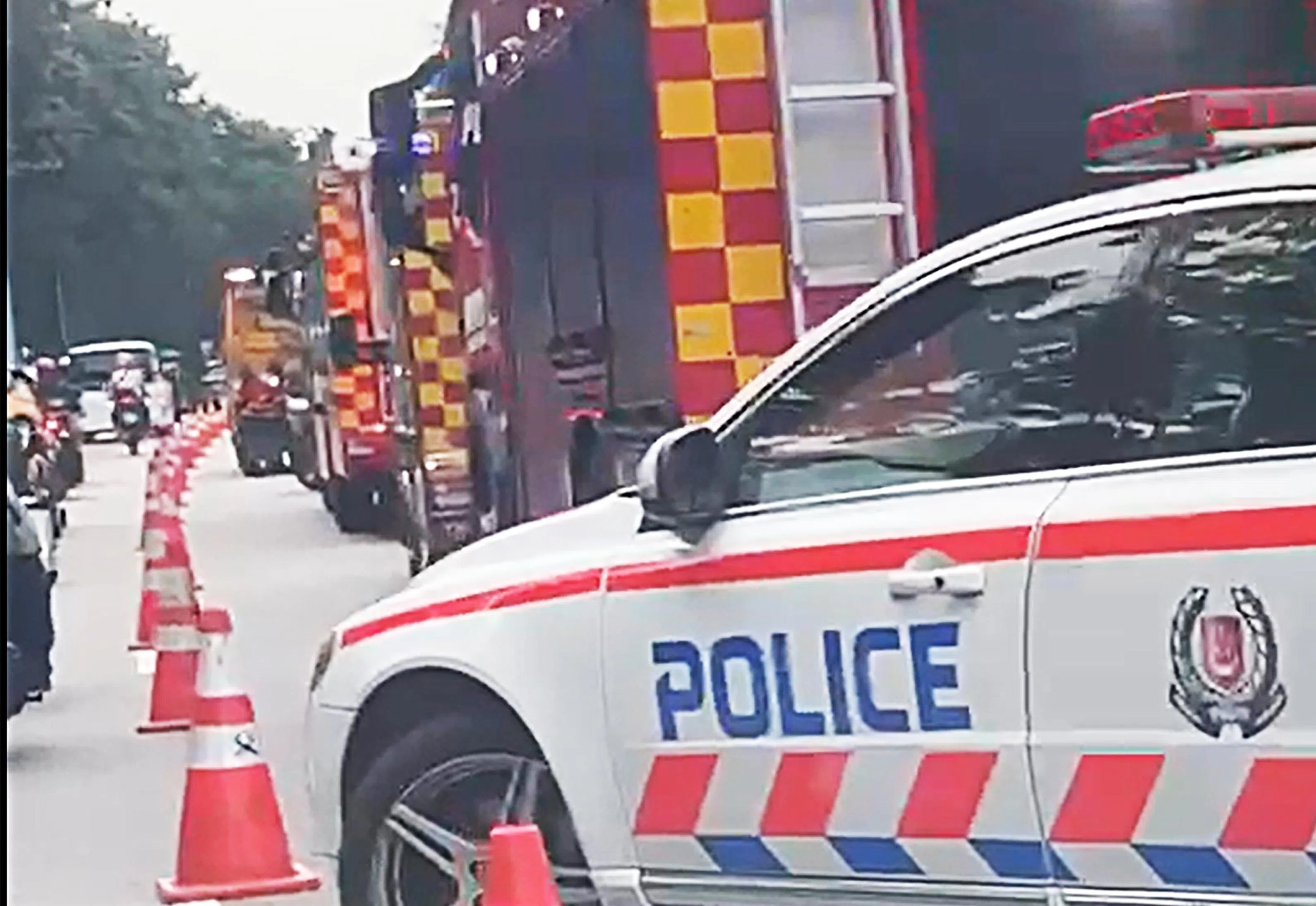 事故发生在最右边车道，路上停了至少三辆消防车，交警在指挥交通，沟渠旁围着不少医护人员。（受访者提供）