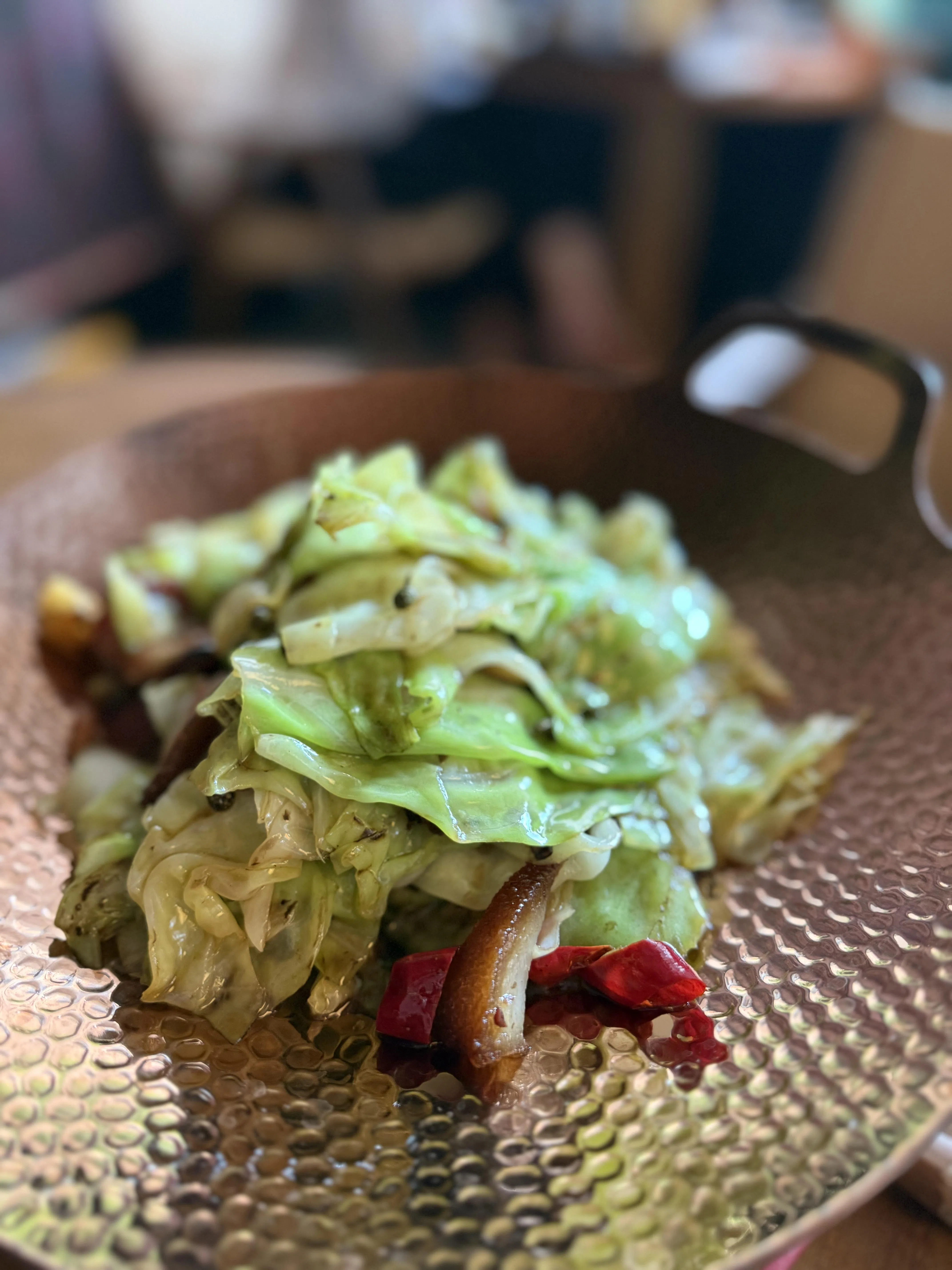 干锅腊肉包菜在大火快炒下带着焦边的香气，清脆爽口。（叶晓虹摄）