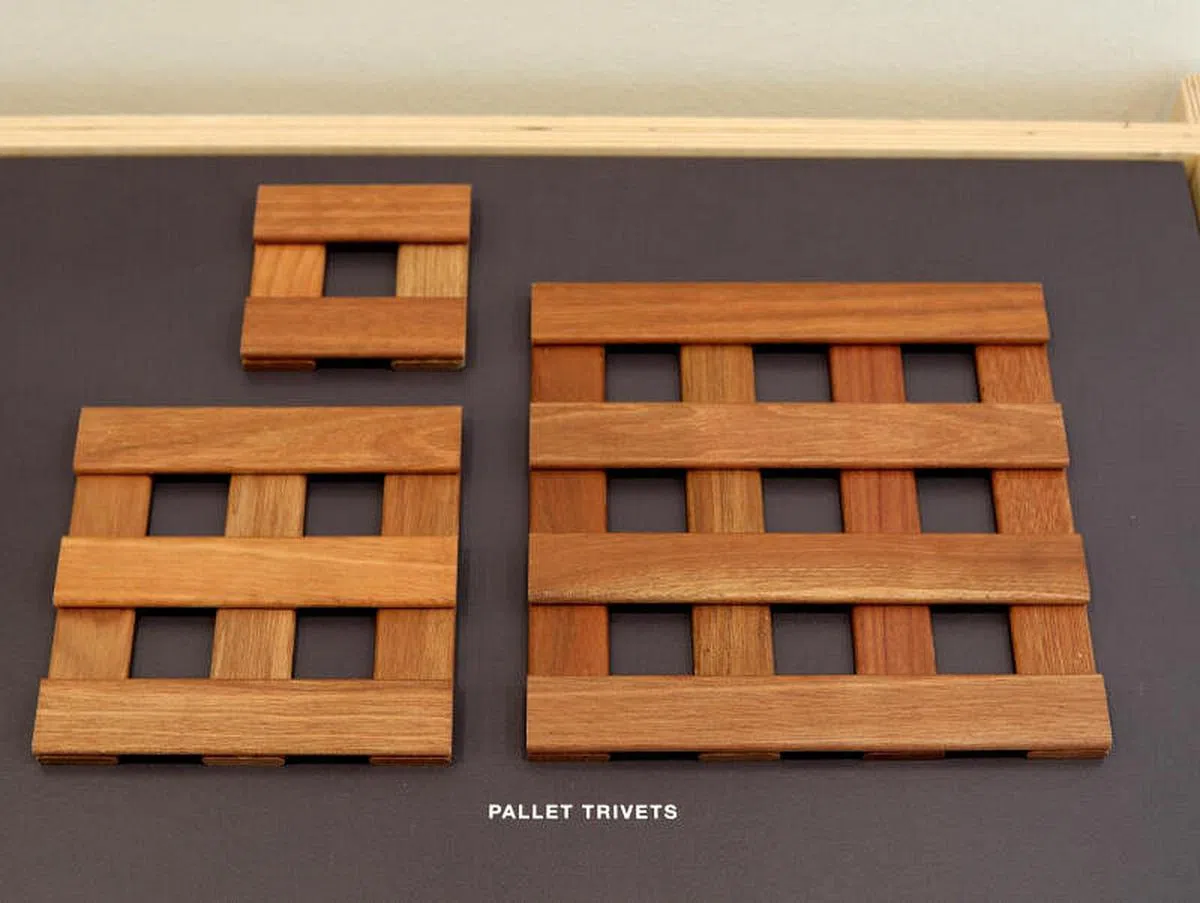 经过老木匠的巧手，剩木制成隔热用的锅垫。 