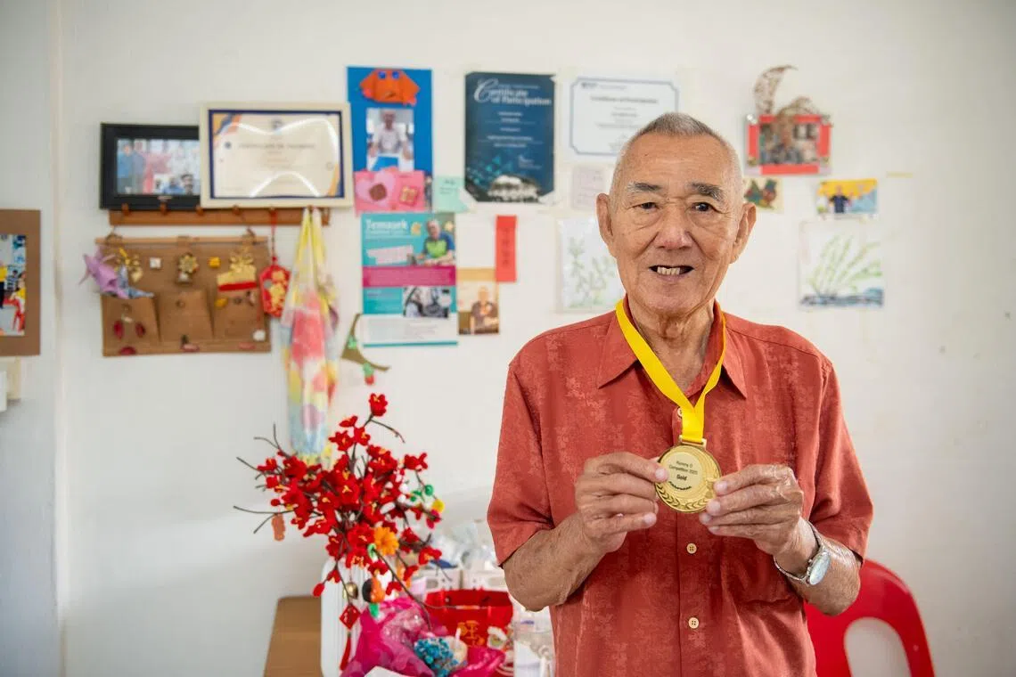 陈成金每周都会到住家附近的狮子乐龄之友协会活跃乐龄中心参加活动，还在中心去年举办的拉密牌大赛中，夺下第一名。家中的墙上贴满他参与各种活动的证书。（特约摄影陈佳誉摄）