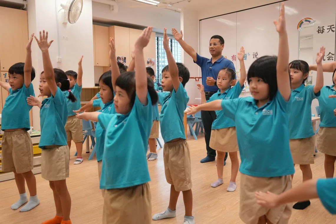 教育部长李智陞走访绿洲小学，并参观设在小学内的教育部幼儿园，与正在上华文课的学生一起利用肢体动作，学习汉字笔画。 （谢智扬摄）