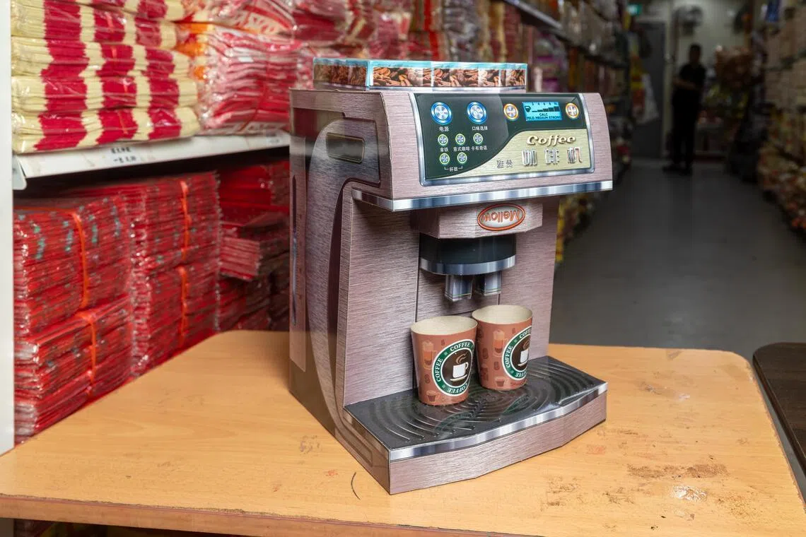 由于母亲生前喜爱喝咖啡，有消费者为往生的母亲购买咖啡机纸扎品。（吴先邦摄）