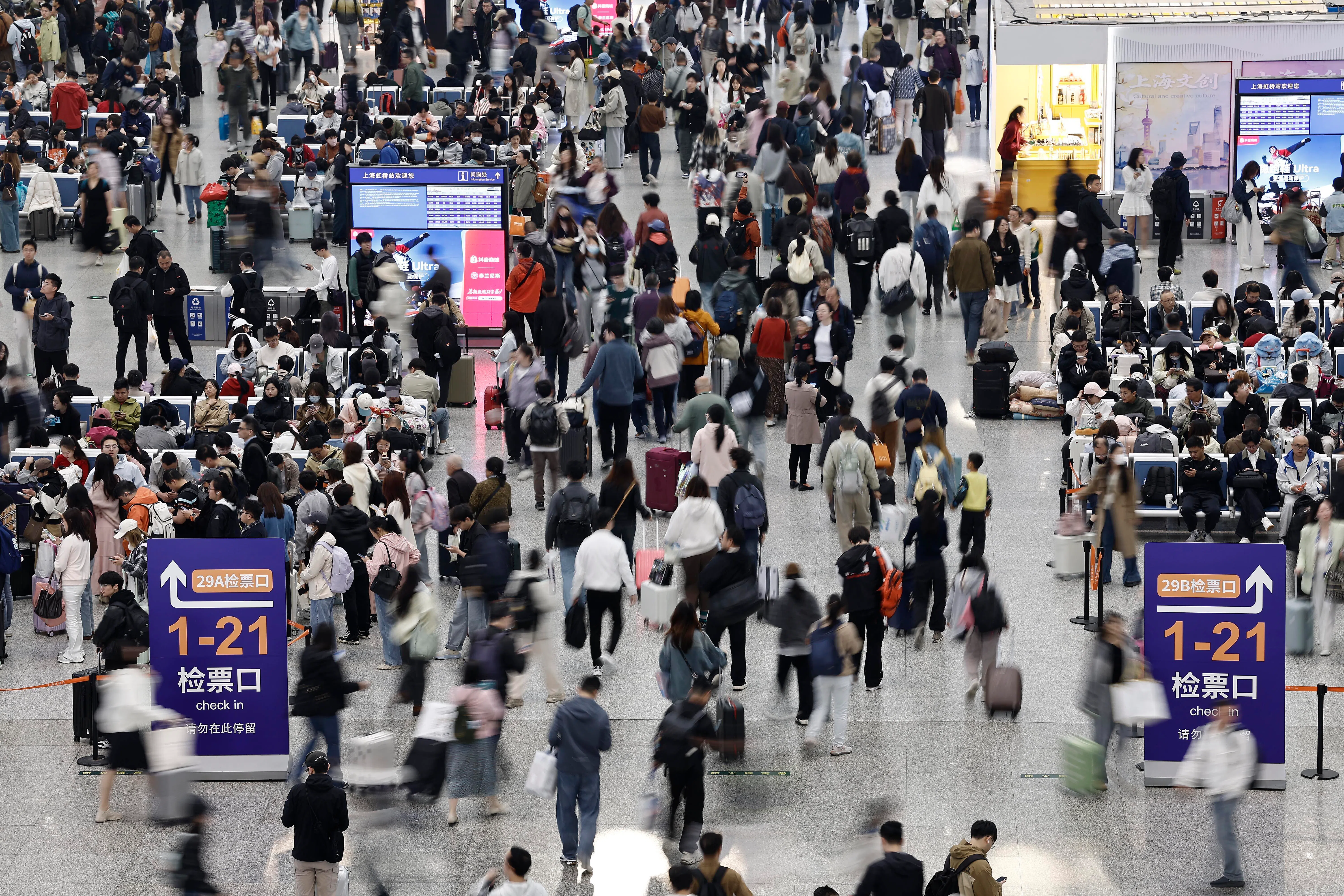 5月1日，旅客在铁路上海虹桥站候车大厅内行走。（中新社）