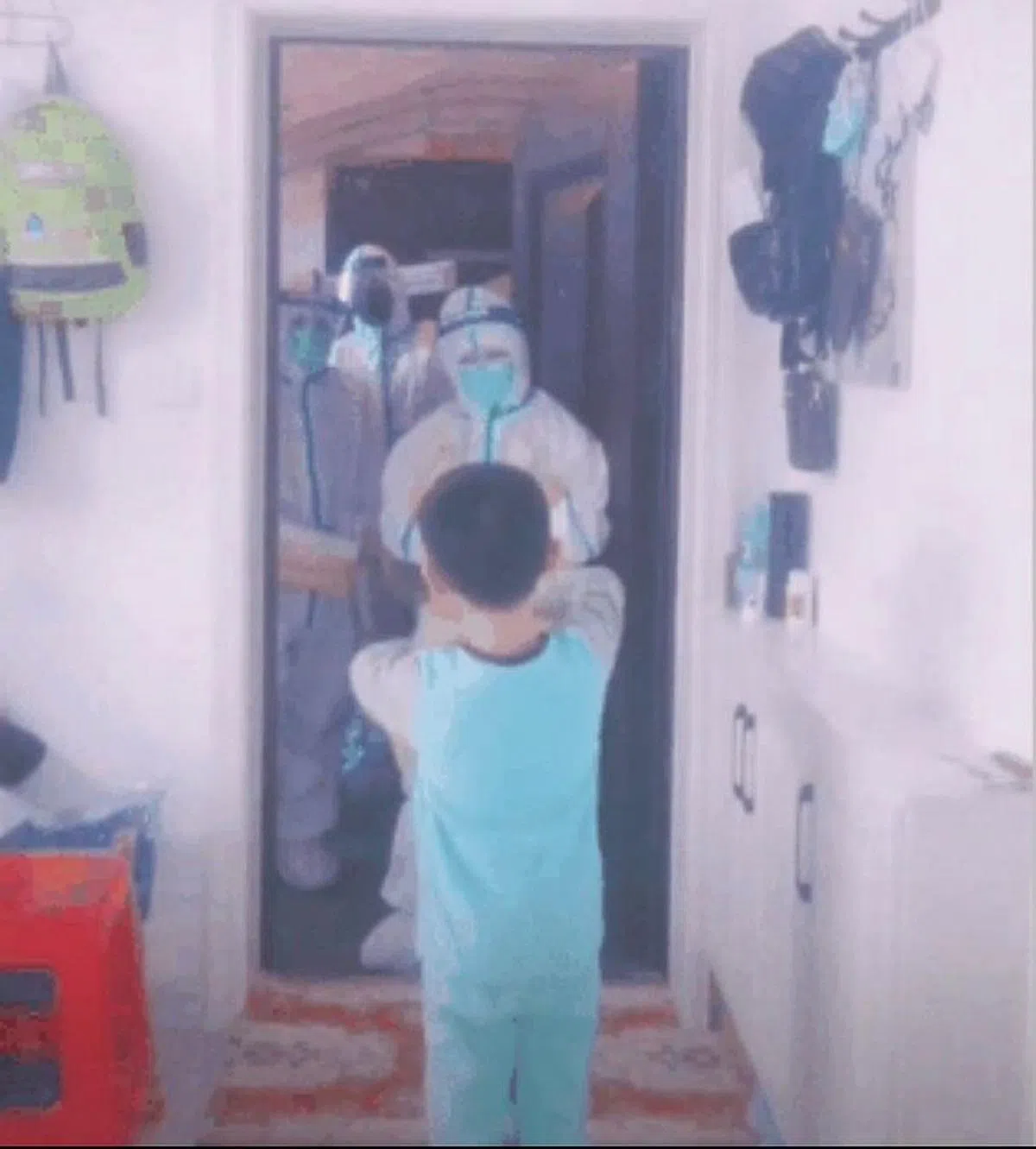 防疫人员上门检测时，在门口观看小孩子的跳舞表演。（视频截图）