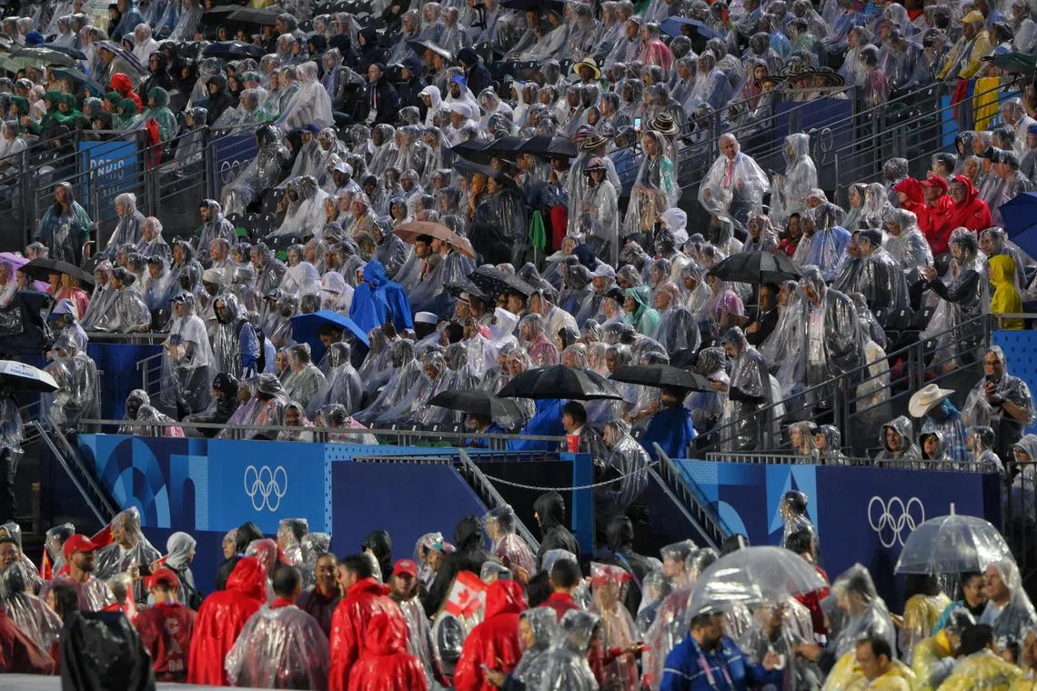 巴黎奥运会开幕式下起了不小的雨，但大部分的观众都有备而来。（海峡时报）
