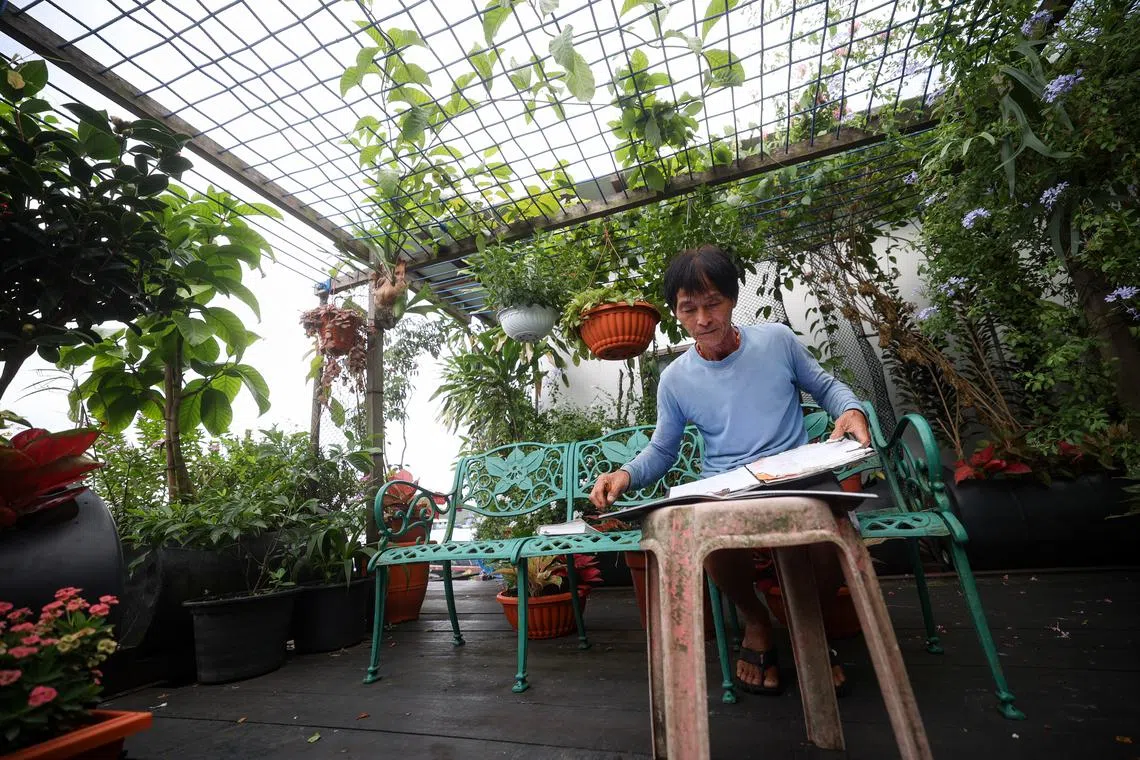 林鑫源在本子上记录鱼儿的生长周期和换网日期，确保它们健康生长。（关俊威摄）