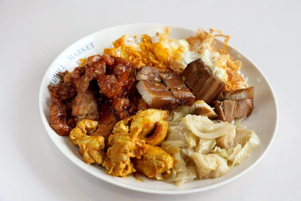 鸿森咖喱饭的“四大天王套餐”有招牌菜猪扒、咖喱鸡、卤肉和包菜。（龙国雄摄）