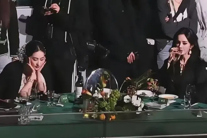 刘亦菲（左）和杨幂同桌尴尬瞬间，一个喝水，一个瞪着空盘，毫无互动。（互联网）