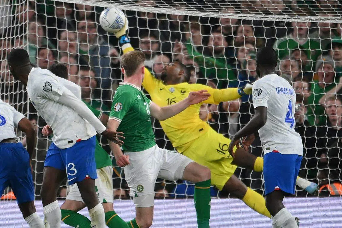 迈尼昂（黄衣）在球赛最后关头的扑救为法国队守住了最后胜利。（法新社）