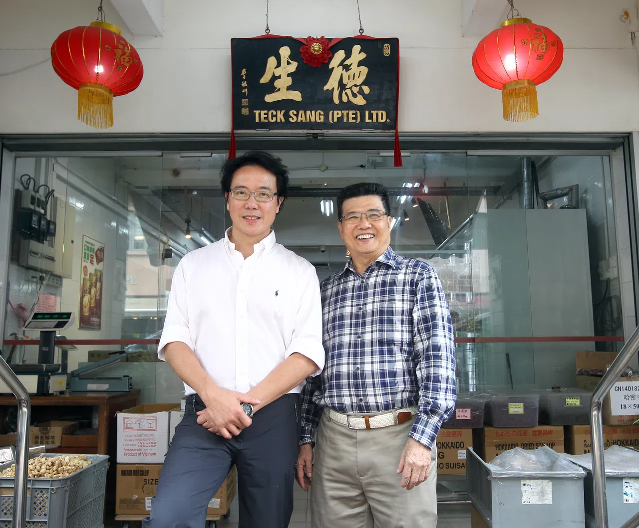 本地罐头鲍鱼老字号品牌“全家福”创办人张荣发（右）将经营30多年的品牌顶让给“德生”海味铺第二代接班人薛建兴（左）。（档案照片）