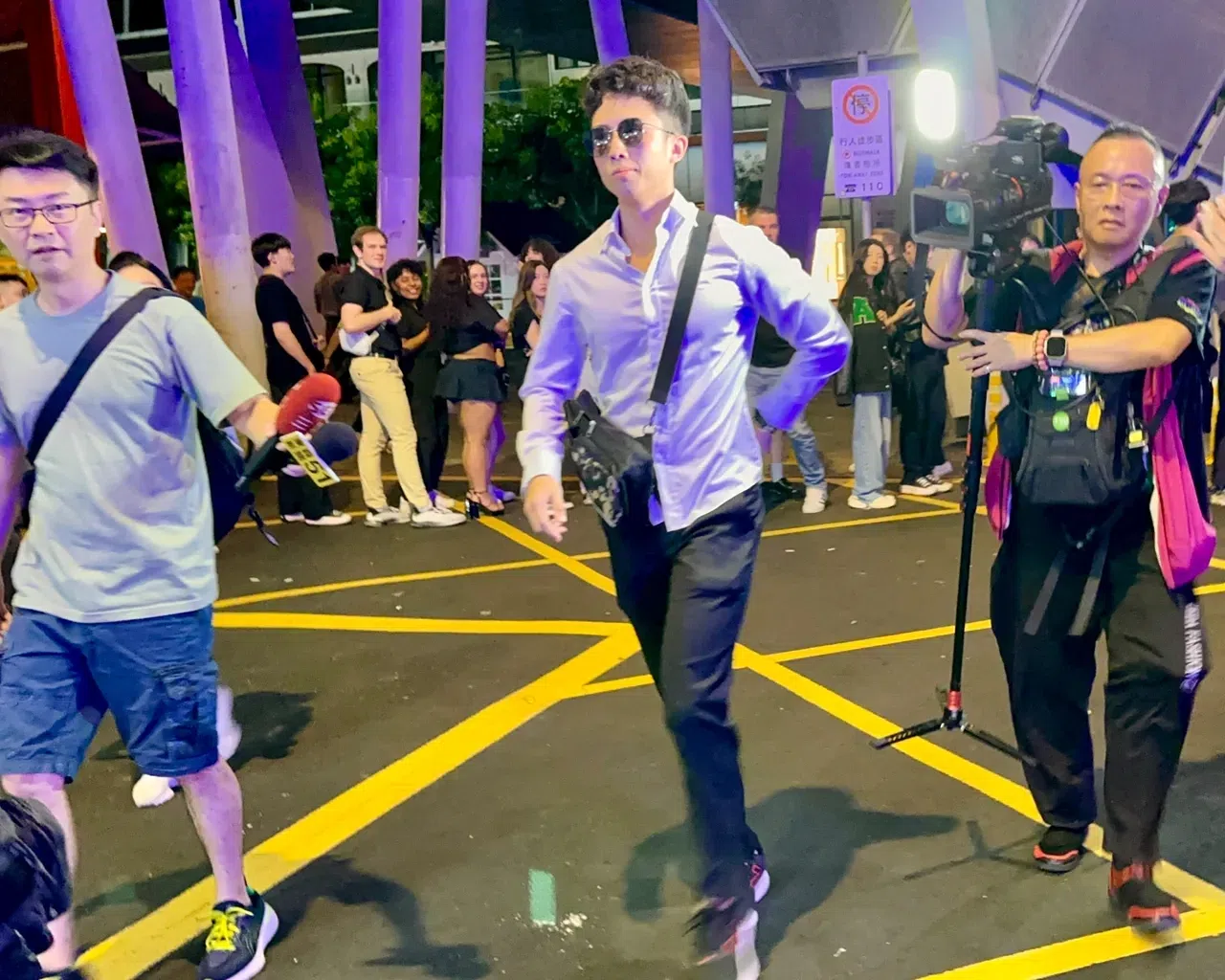 孙安佐（中，戴墨镜者）近来行经脱序，引来媒体竞相采访。（互联网）