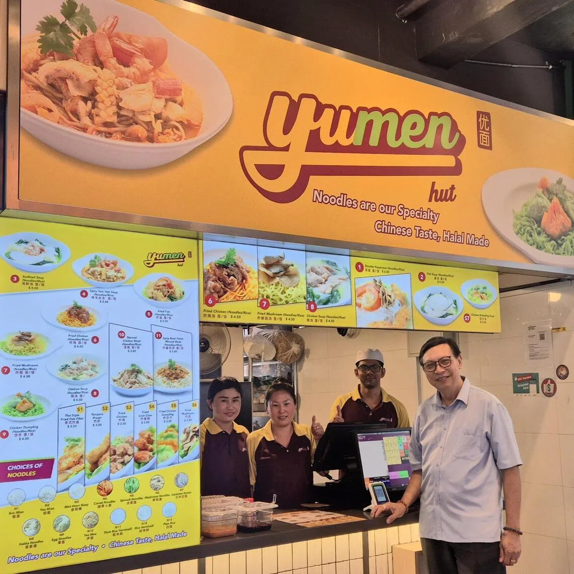 优面老板萧永祥（右）和忠实员工，很高兴能在宏茂桥重新开档。（陈爱薇摄）