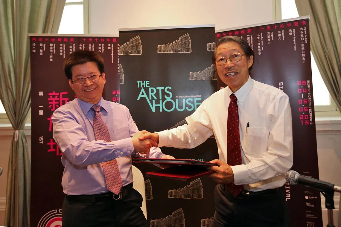 陈继贤（左）在2013年举行的第一届“新加坡华语电影节”上，与新跃中华学术中心前主任郭振羽签署备忘录，致力将新加坡华语电影节打造为本地年度盛事之一。（档案照）