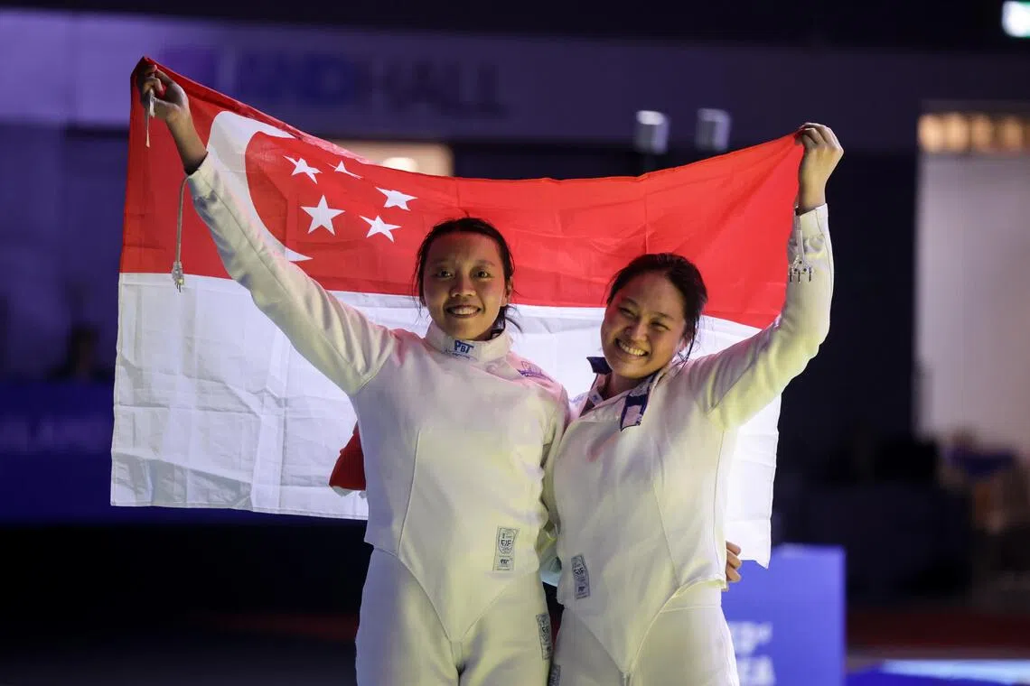 友谊第一，比赛第二。可丽雅（左）和许渼荟在赛后一起举国旗合影。（白艳琳摄）