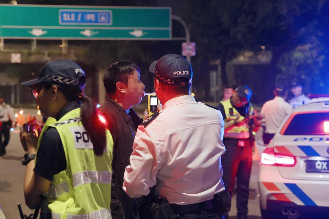 驾驶者接受酒精呼气测试。（邬福梁摄）
